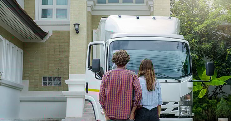 Couple looking at truck when moving at Christmas