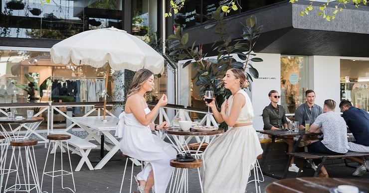 Two young women eat outside of Brisbane restaurant
