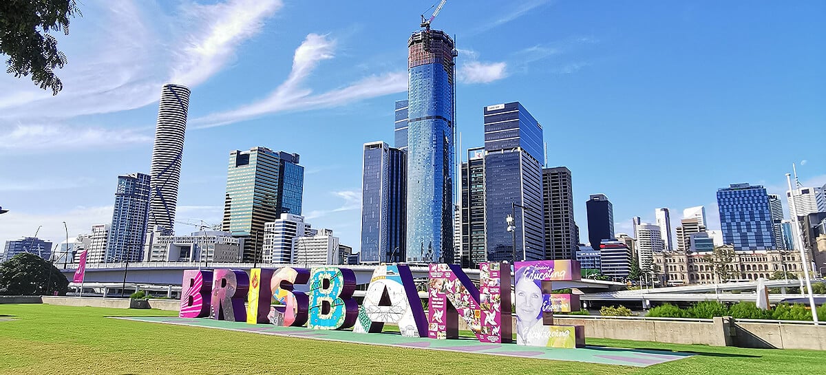 Brisbane letter sign in front of skyline