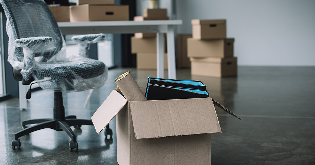 Business files in boxes with business chair in bubble wrap waiting for business relocation