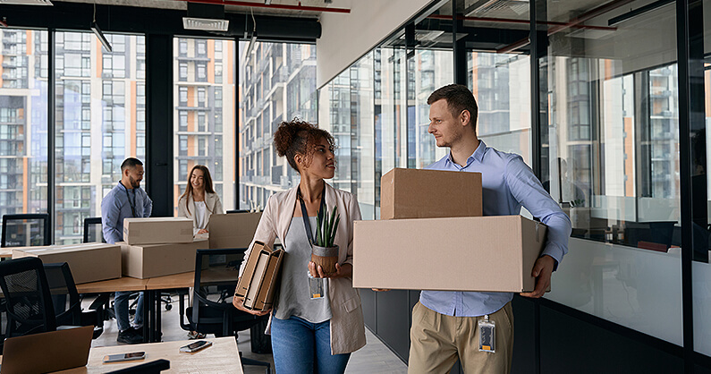 Office workers packing and moving offices