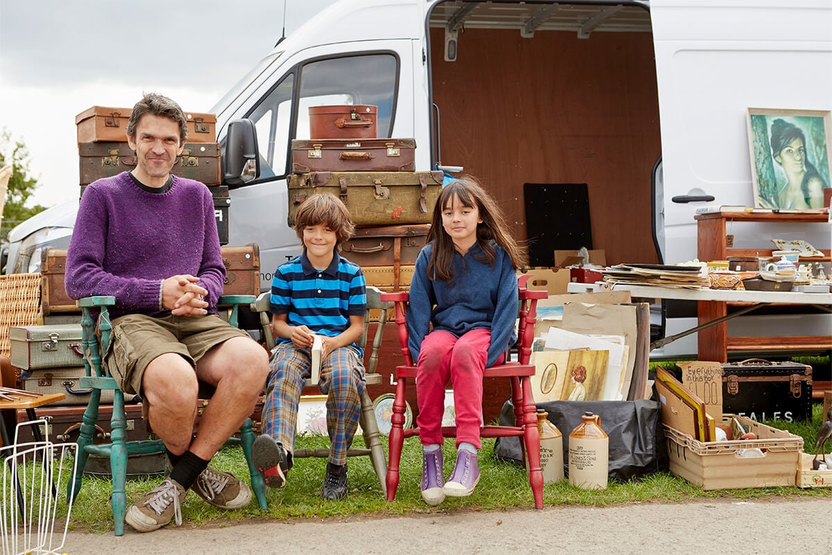 Family sit ready to sell to locals at their garage sale