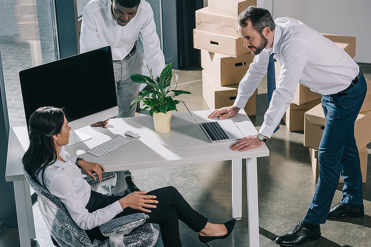 Team sit in office furniture brought in by office removalists