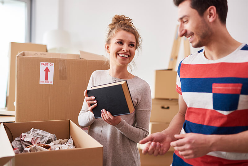 Young couple pack heavy duty boxes