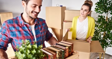 Happy couple packing and moving