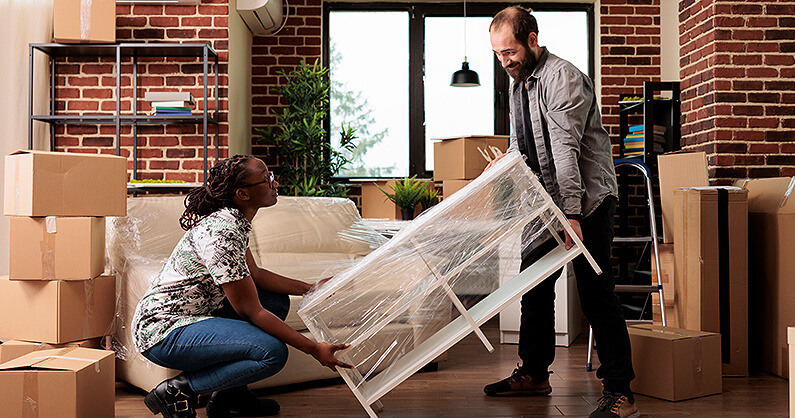 Man and woman moving furniture of donation