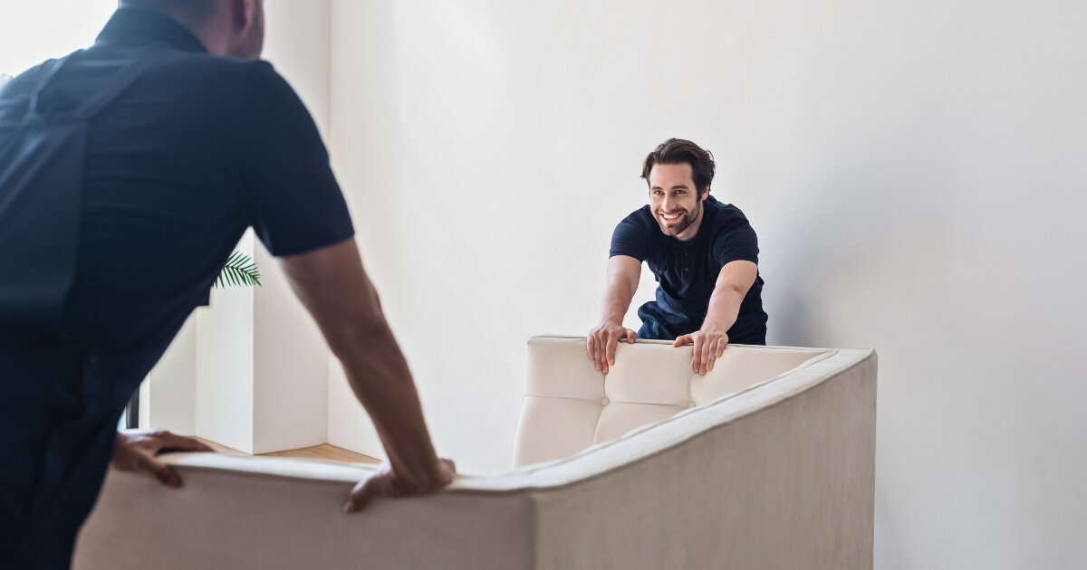 Two furniture movers moving a couach in Brisbane