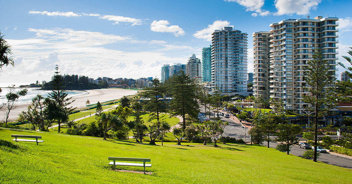 View of Gold Coast from green hill with high rises and beach in background