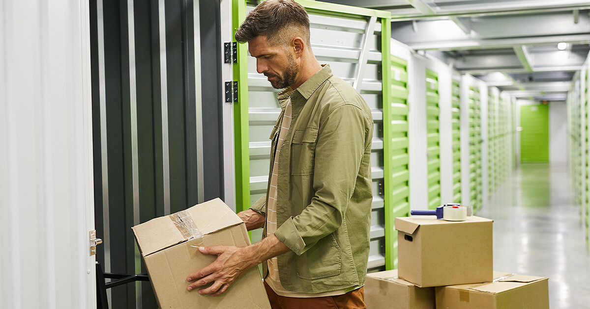 Man moves boxes into the best long-term storage containers