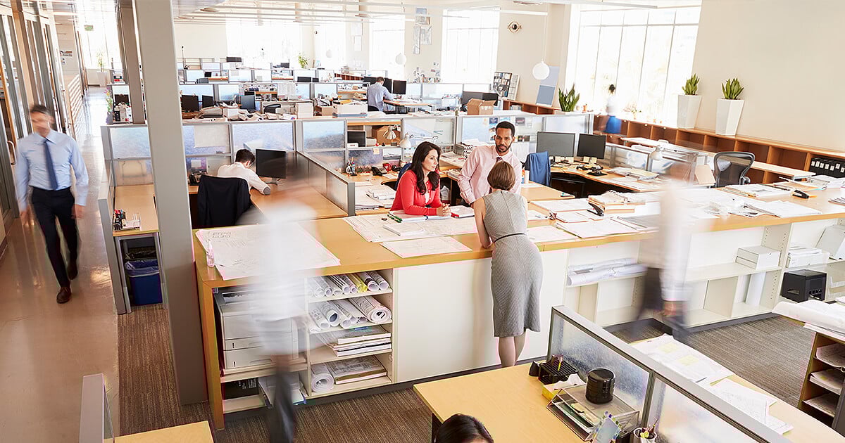 Large office area with team members moving around