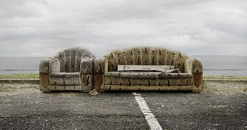 Old couch on a road as furniture waste