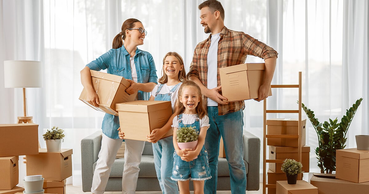 Family holding packing boxes Brisbane ready to move home