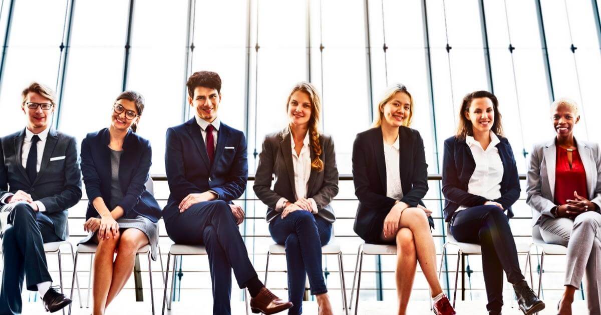 people in business suits sitting in chairs