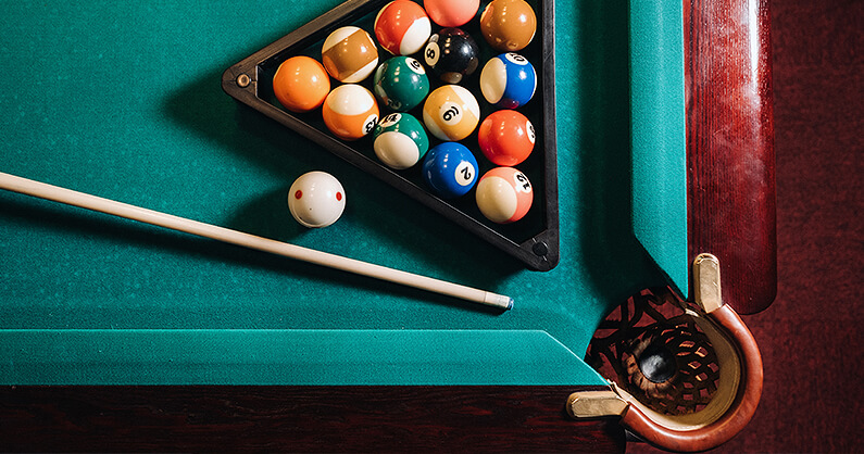 Pool table corner pocket with cue and balls