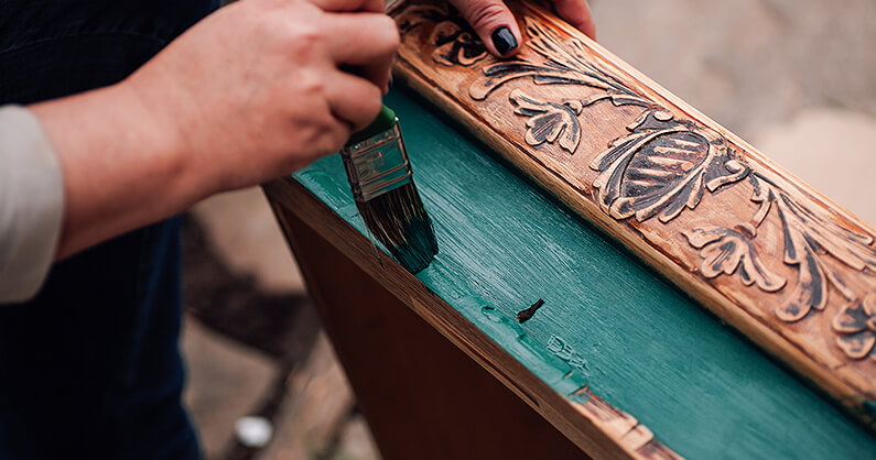 Restoring old furniture by painting to prevent furniture waste