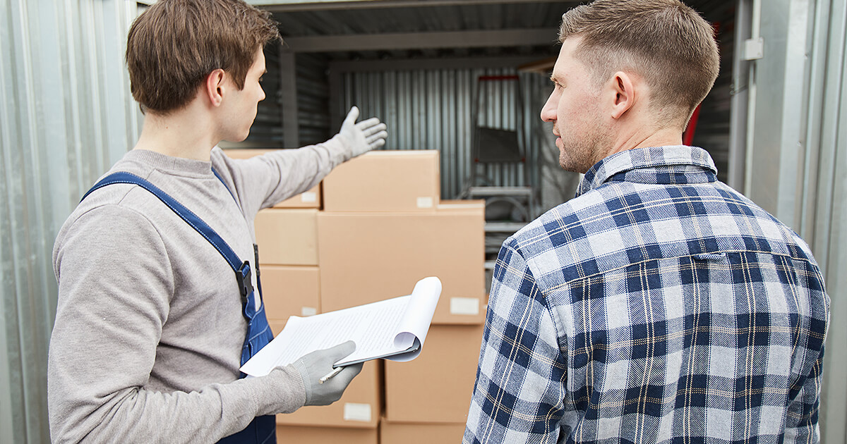 Storage specialist explains features of shipping container storage to potential customer