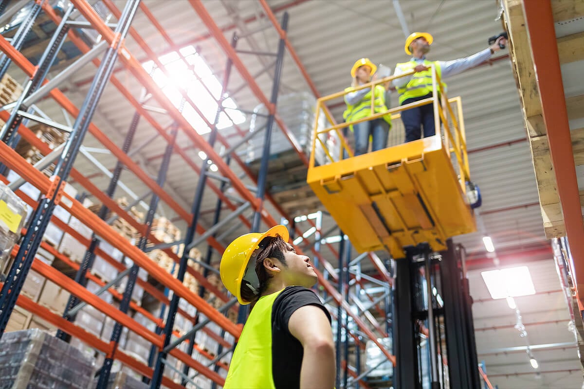 Warehouse workers checking on crates in new storage facility