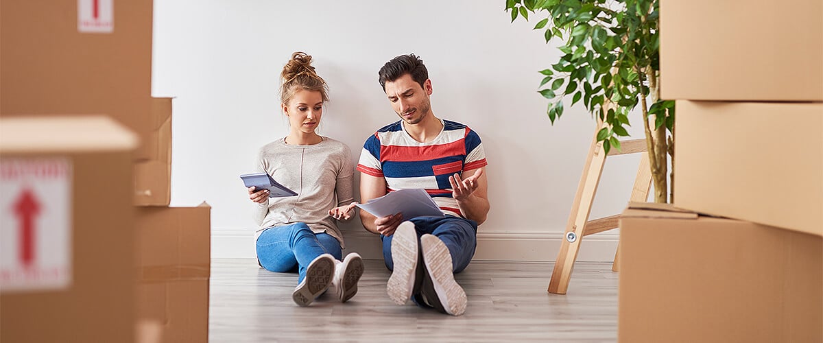 Couple worried about moving sitting between boxes