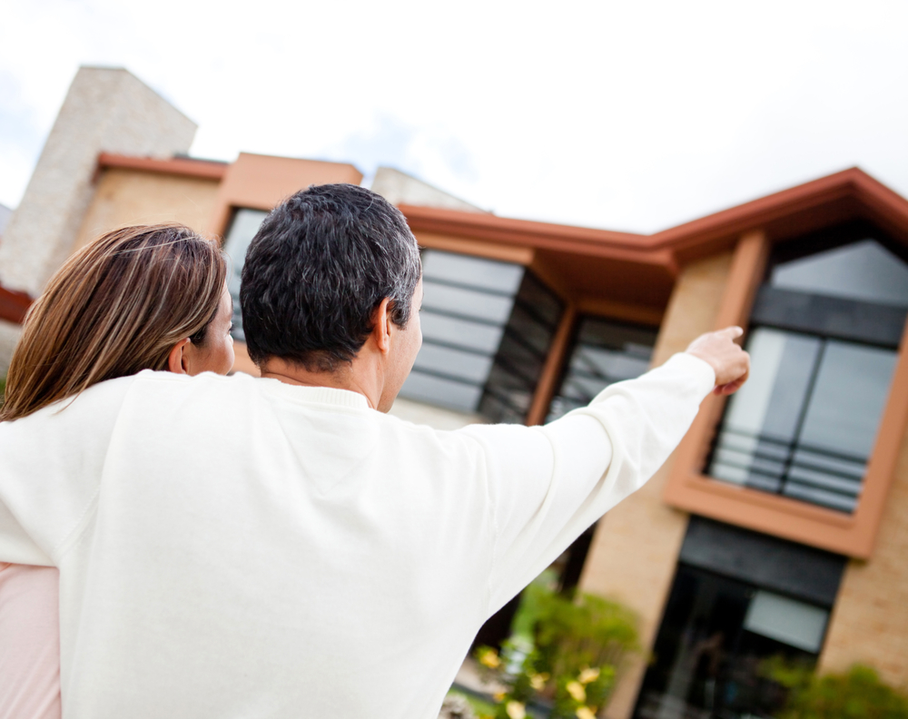 Couple pointing at their lovely dream home