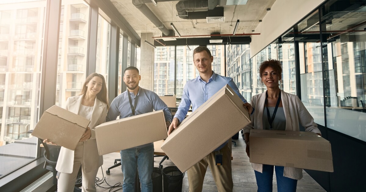 4 Business People with Boxes During a Business Relocation