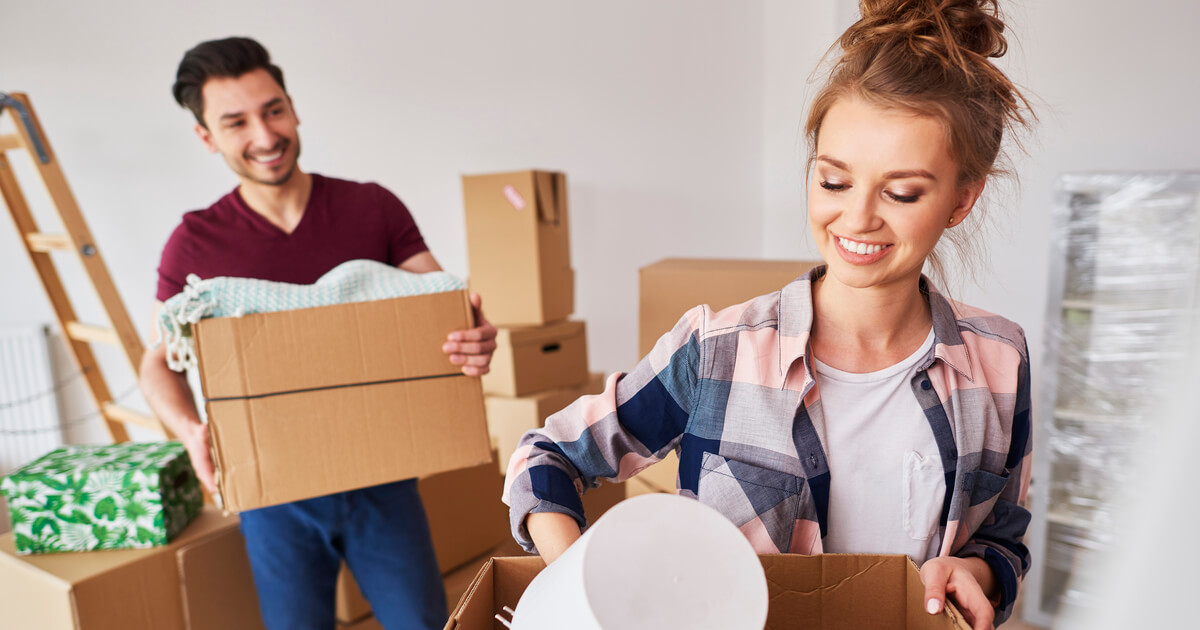 Man and woman packing boxes, getting ready for removals