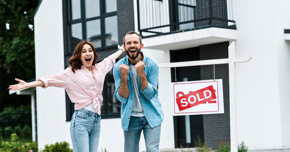 Happy couple buying a house