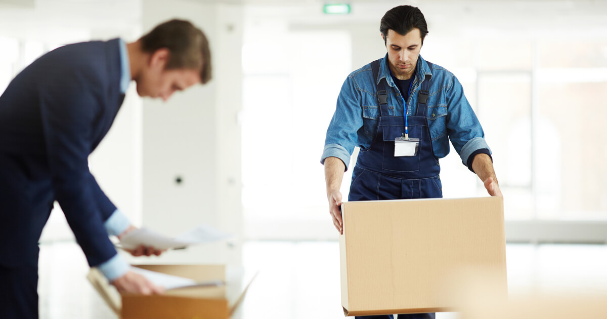 Businessman receiving help from a furniture removalist