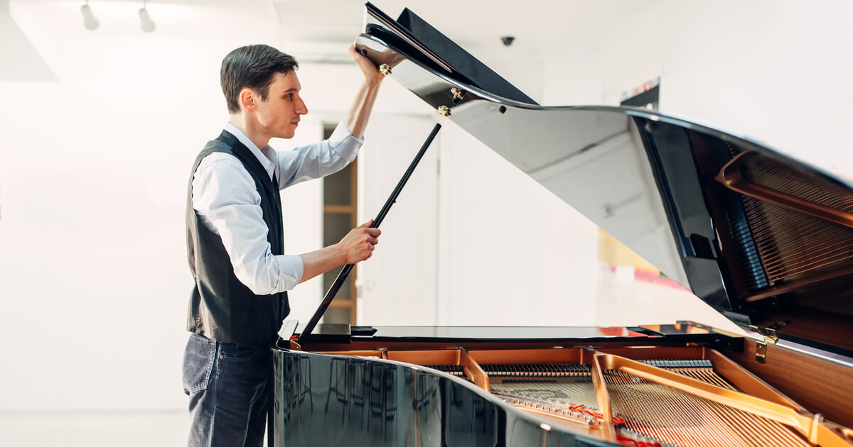 Man Lifting lid on piano 