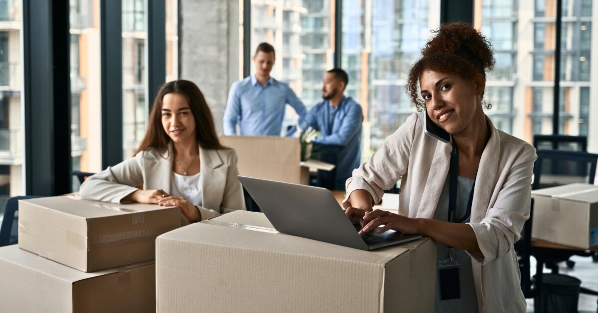 Happy office workers moving offices