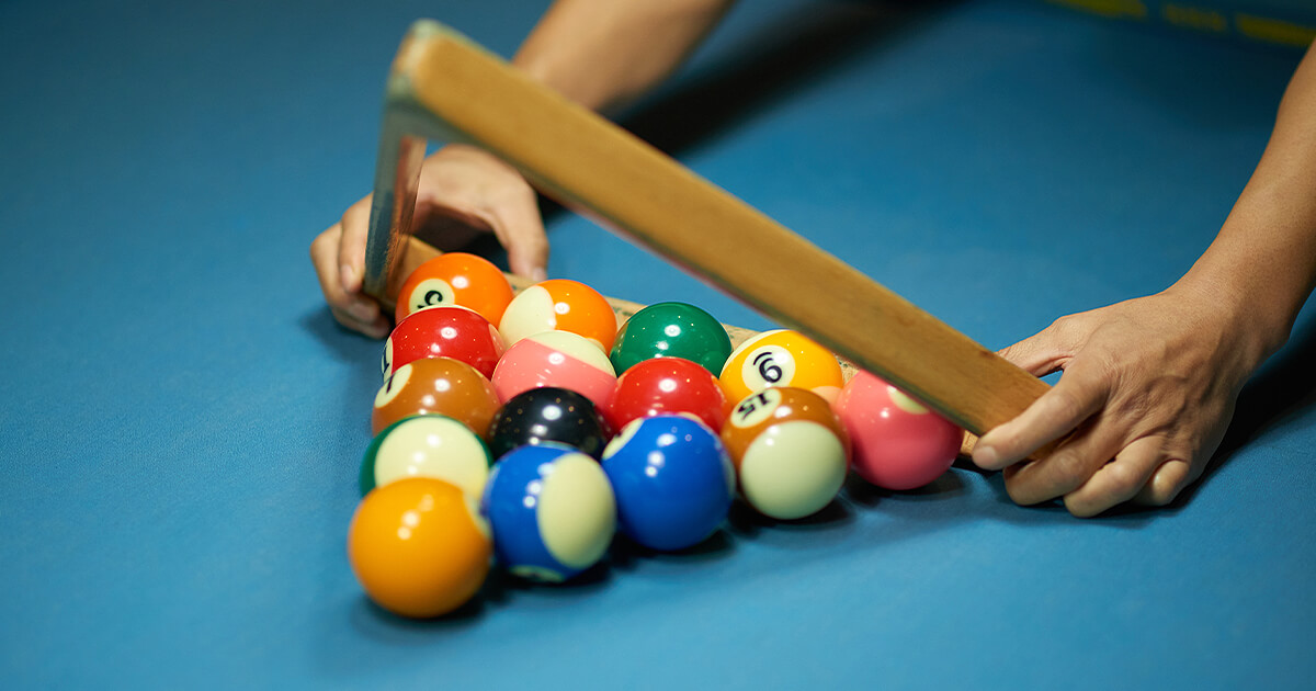 Setting up billiard balls on pool table