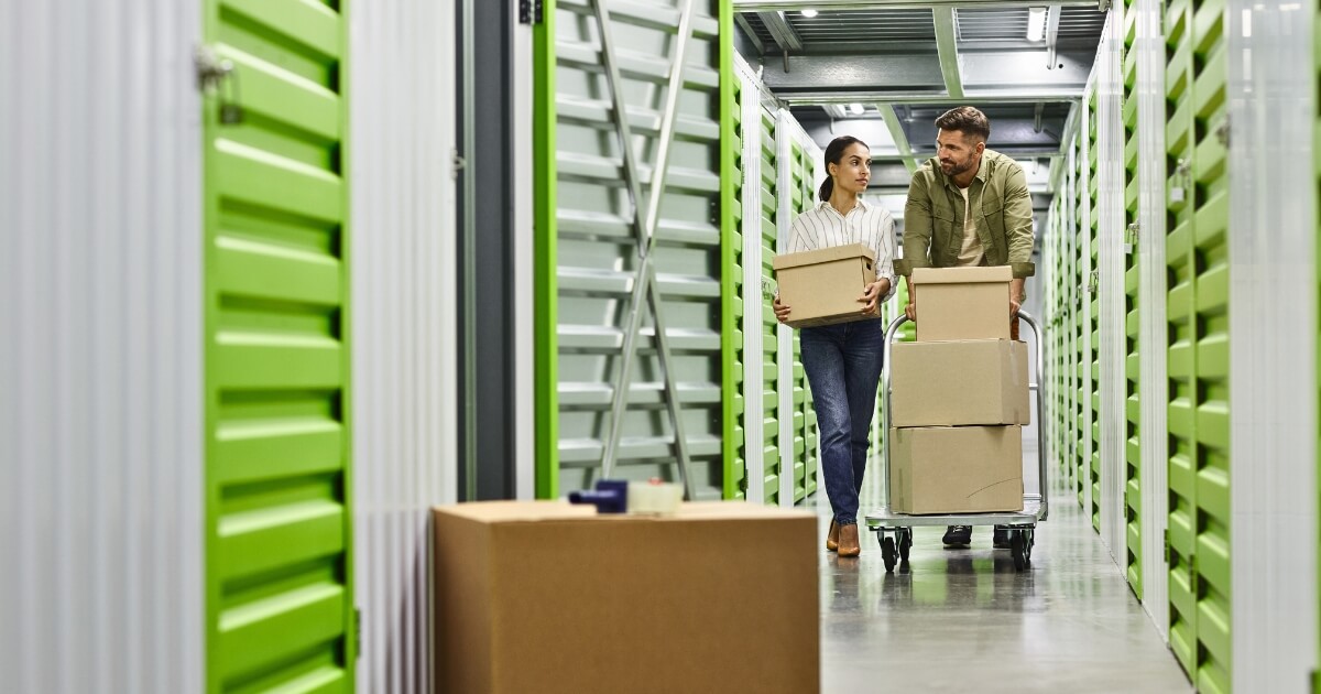 Couple moving their things into self storage with boxes