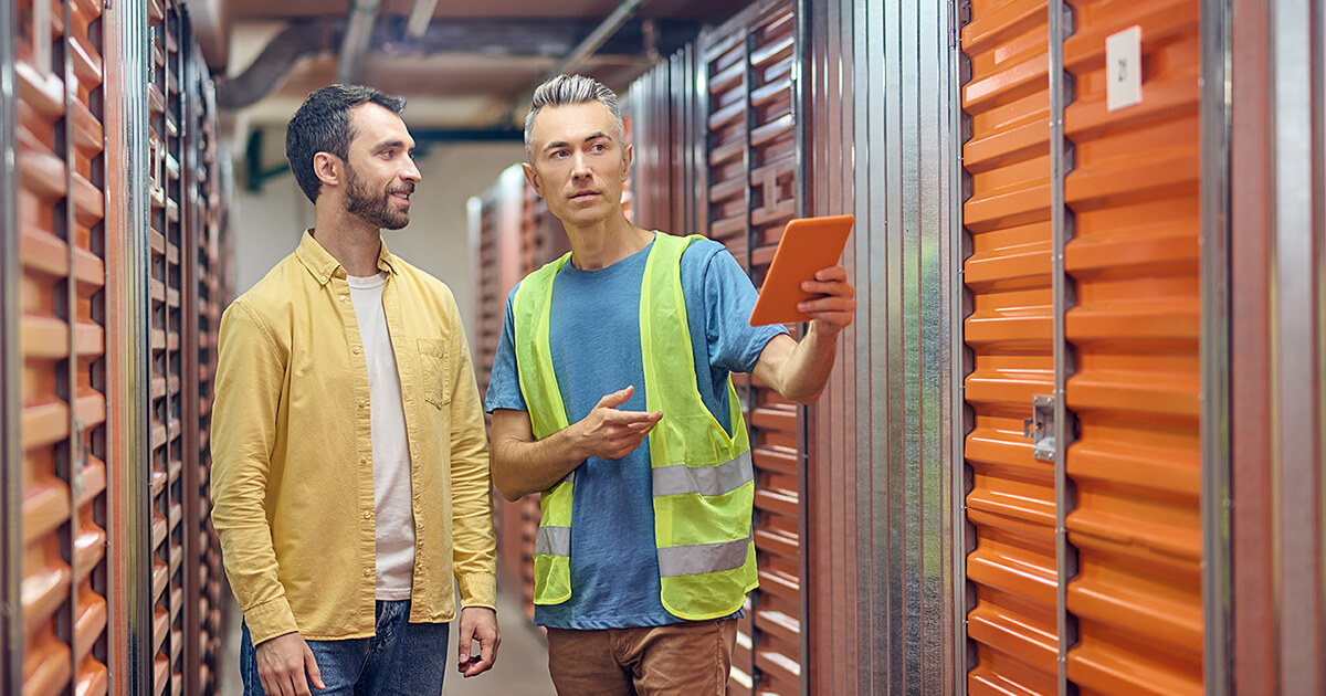 A man looking at storage units to store his house items in.