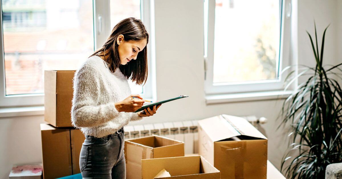Women surrounded by boxes and checking list