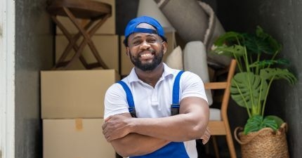Happy removalist in front of truck